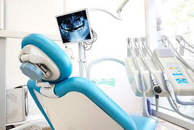 Dental chair and tools, with view of an x-ray at our Houston Dentist Office.