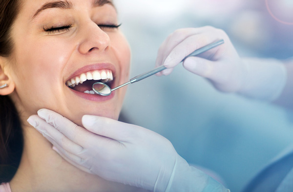 Woman getting dental exam in Houston at Frank Dunlap, DDS